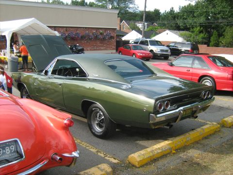 1988 Mercury Grand Marquis - A green 1968 Dodge Charger is parked at an outdoor event with its hood open.