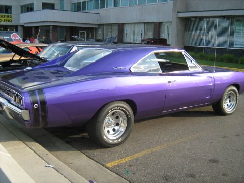 1988 Mercury Grand Marquis - A purple 1968 Dodge Charger is parked next to another vehicle.