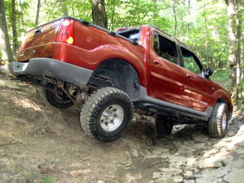 2002 Ford Sport Trac - This red 2002 Ford Sport Trac navigates a challenging rocky trail, its off-road capabilities.