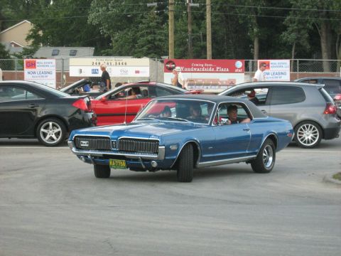 1988 Mercury Grand Marquis - Blue 1969 Mercury Cougar XR-7 coupe seen on the road with other vehicles.