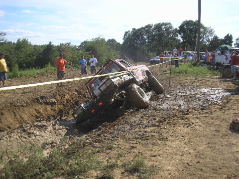 2002 Ford Sport Trac - Off-road vehicle stuck deep in a mud pit during an event.