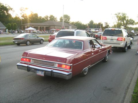 1988 Mercury Grand Marquis - A classic red Mercury Marquis cruises down the road during a car event.