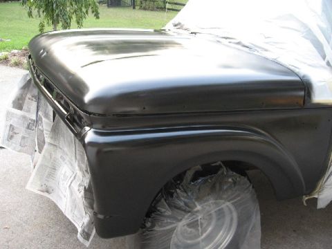1966 Ford F-100 - A truck's front end is being prepped for paint, with protective coverings in place.