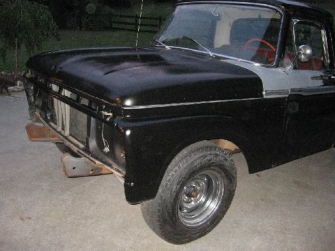1966 Ford F-100 - A black and silver 1965 Ford F-100 truck is shown from the front, with its grille removed.