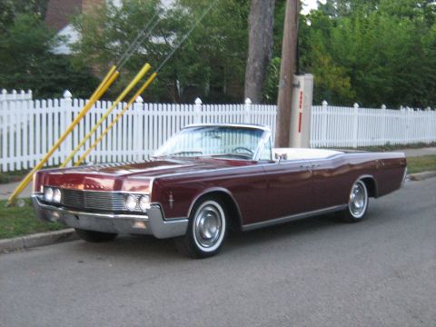 1988 Mercury Grand Marquis - A classic Lincoln Continental convertible is parked on a residential street.