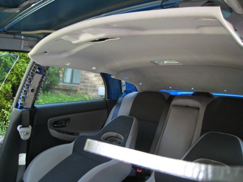 2007 Subaru Impreza - The interior of a 2007 Subaru Impreza is shown with the headliner partially removed, revealing the car's structure.