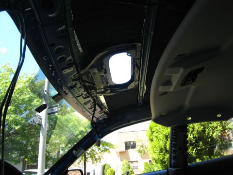 2007 Subaru Impreza - The interior roof structure of a vehicle is visible, showing exposed metal and wiring around the sunroof opening.