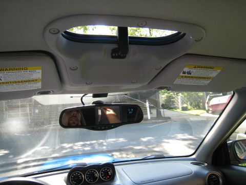 2007 Subaru Impreza - The interior of a vehicle is captured, highlighting the sunroof and dashboard instruments.