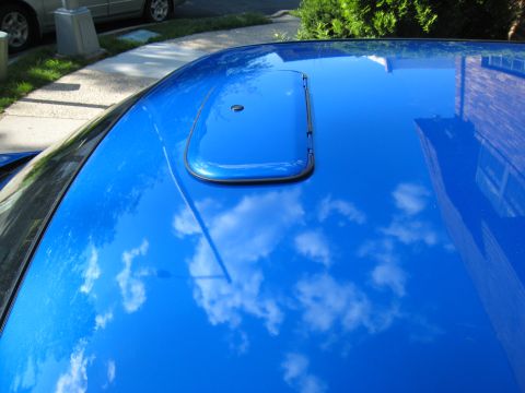 2007 Subaru Impreza - A close-up view of a blue car's roof, showing a sunroof and reflections.