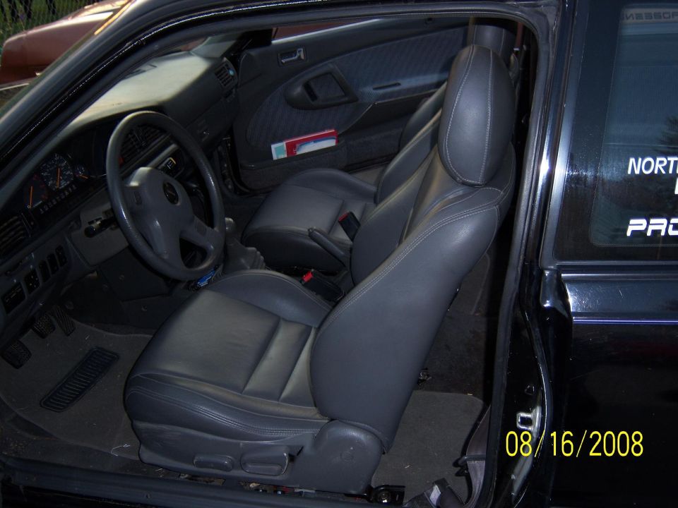 Interior view of a 1989 Mazda MX-6 showing gray leather seats and dashboard