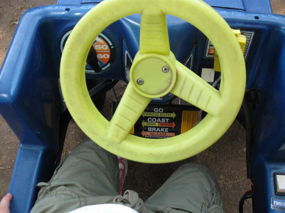 Blue toy car interior with yellow steering wheel and dashboard gauges