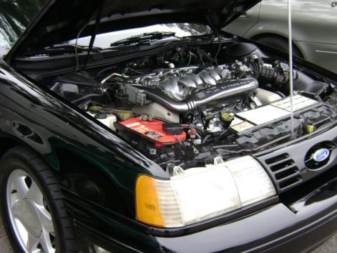 1991 Ford Taurus - Engine bay view of a 1991 Ford Taurus, highlighting the V6 engine and front grille detail.
