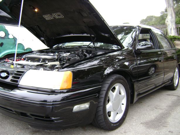 Black 1991 Ford Taurus SHO with hood open, showing engine.