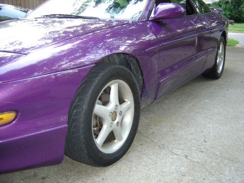 1994 Ford Probe - A purple 1994 Ford Probe is parked on a concrete surface, viewed from the front passenger side.
