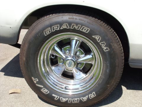 1978 Ford Mustang II - A close-up view of a tire and chrome wheel on a white vehicle.