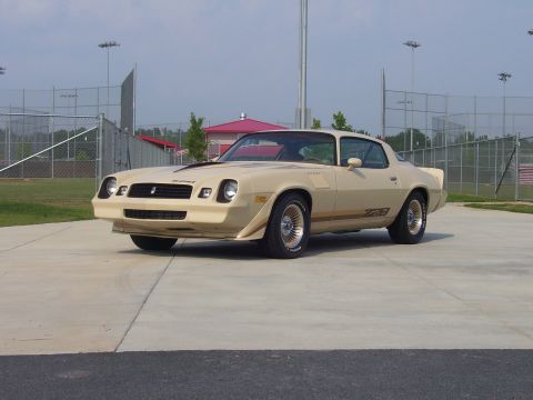 1979 Chevrolet Camaro - This 1979 Chevrolet Camaro Z28 features distinctive gold striping and wheels, complementing its tan exterior.