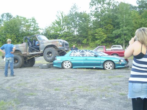 1979 Ford Bronco - A heavily modified 1979 Ford Bronco is positioned to crush a teal sedan in a car crush event.