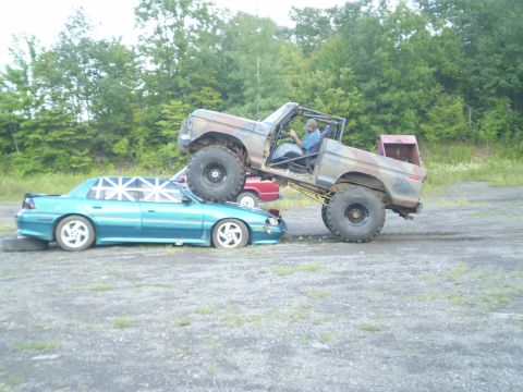 1979 Ford Bronco - A lifted 1979 Ford Bronco is shown crushing a teal sedan in a car crush event.