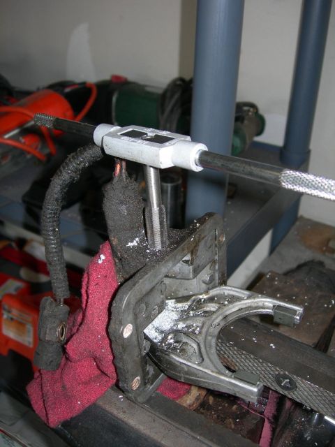 1991 Jeep Wrangler - A tap and die set is used to create threads on a metal part secured in a vise.