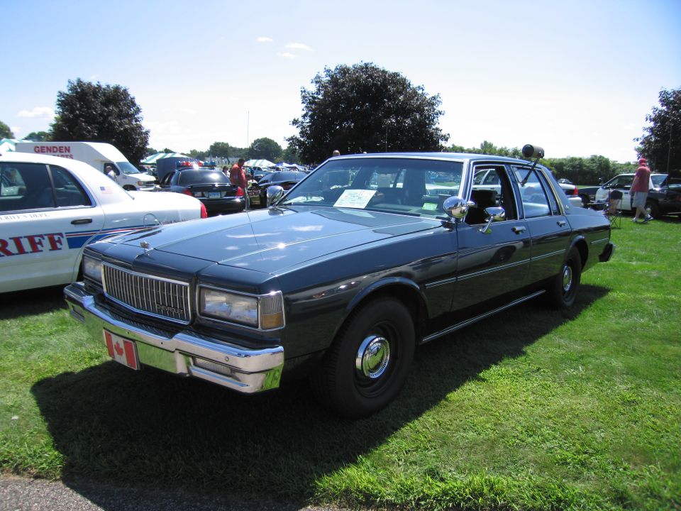 Dark blue Chevrolet Caprice sedan with Canadian flag plate at car show