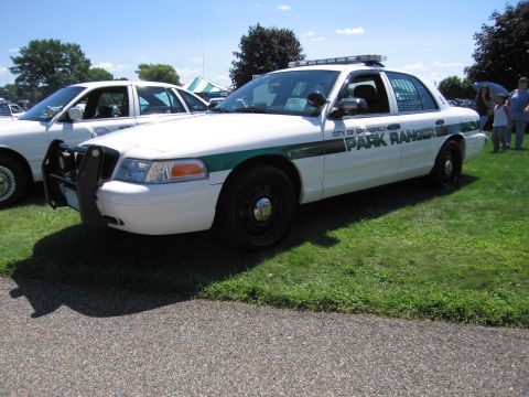 1991 Ford LTD Crown Victoria - white Ford Crown Victoria marked City of Springfield Park Ranger with a green stripe and front push bar at a car show.