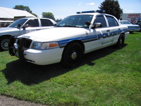 1991 Ford LTD Crown Victoria - white and blue Ford Crown Victoria police cruiser lettered POLICE and Springfield College with push bar and lightbar.