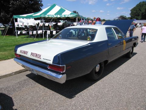 1991 Ford LTD Crown Victoria - Rear view of a blue and white late-1960s Plymouth sedan lettered HIGHWAY PATROL with a roof beacon at a show.