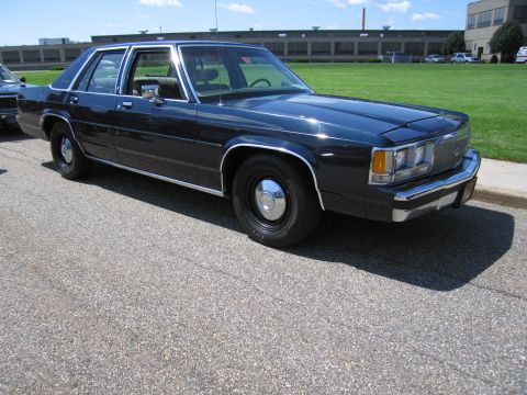 1991 Ford LTD Crown Victoria - dark blue 1980s Ford LTD Crown Victoria sedan with chrome trim and steel wheels parked on pavement at a show.