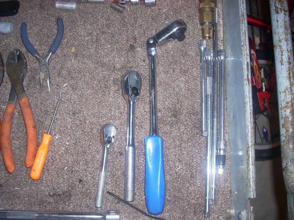 Assortment of wrenches and pliers on carpet
