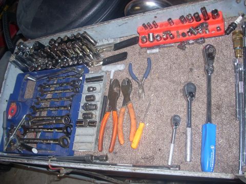 1992 Ford Bronco - A collection of various hand tools, including wrenches and socket sets, are laid out in a toolbox.