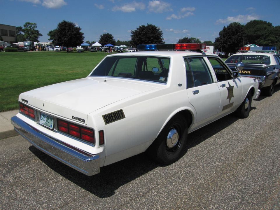 White Chevrolet Caprice SHERIFF sedan with gold star, rear three-quarter