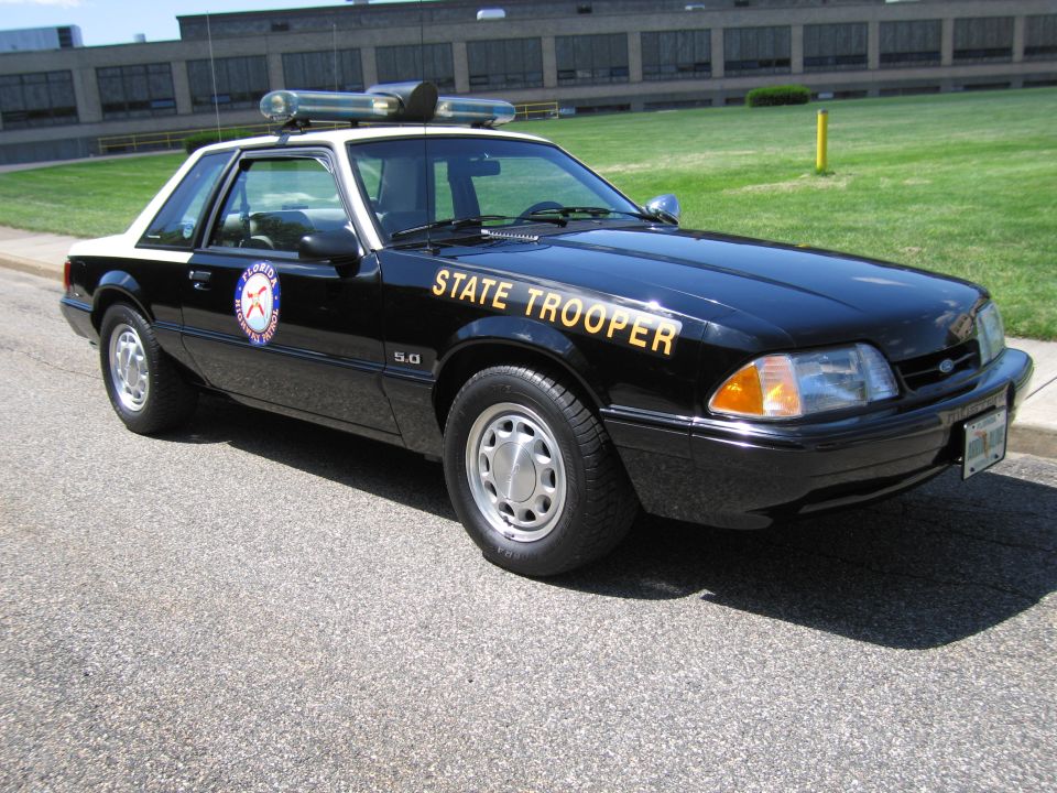 Black-and-white Ford Mustang 5.0 State Trooper coupe with light bar