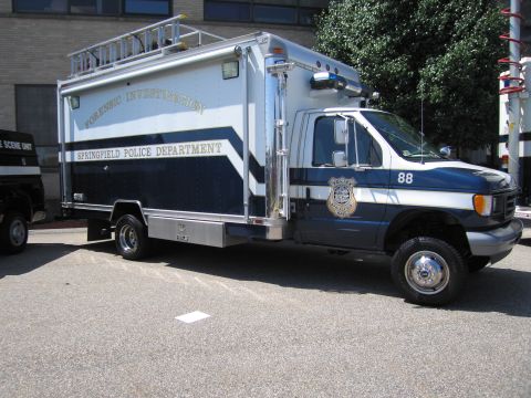 1991 Ford LTD Crown Victoria - blue-and-white Springfield Police Department 'Forensic Investigation' box truck, unit 88, on a Ford cutaway chassis in a lot.