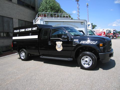 1991 Ford LTD Crown Victoria - black Ford F-250 Super Duty marked 'Police Crime Scene Unit' and 'Springfield,' unit 2632, parked near other emergency vehicles.