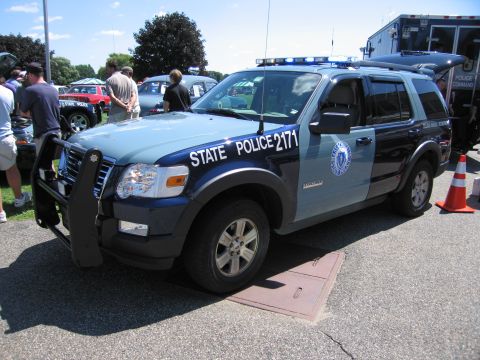 1991 Ford LTD Crown Victoria - blue-and-light-blue Massachusetts State Police Ford Explorer SUV, unit 2171, with a push bar parked on pavement.