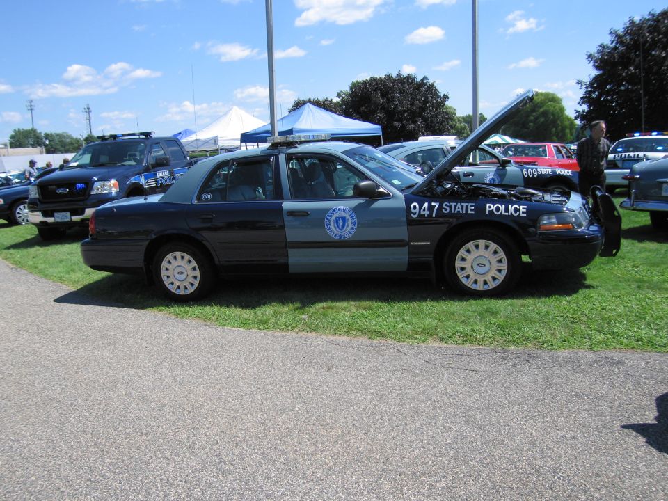 Massachusetts State Police Ford Crown Victoria sedan number 947 with hood up on grass
