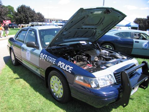 1991 Ford LTD Crown Victoria - Massachusetts State Police Ford Crown Victoria, unit 947, with hood raised exposing the engine bay at an outdoor show.