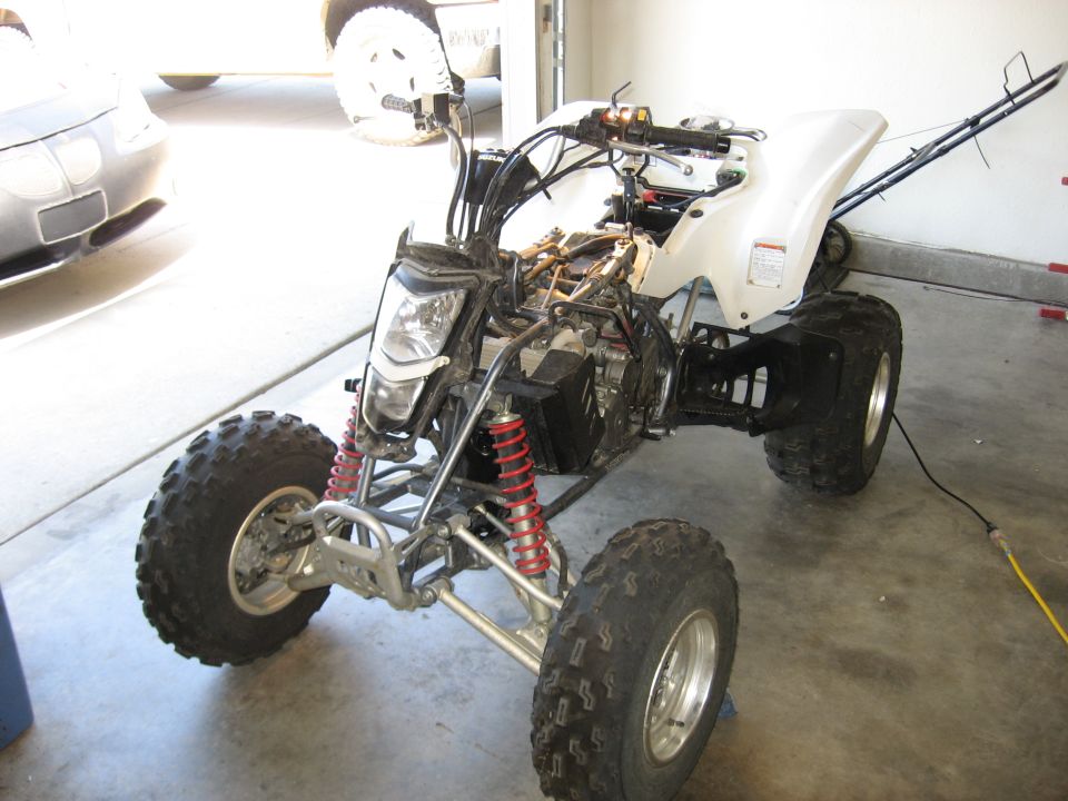 White 2004 Suzuki LTZ400 ATV with exposed engine components, viewed from a 3/4 front angle