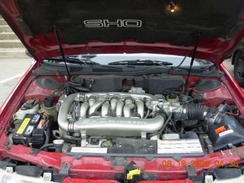 1995 Ford Taurus - Engine bay of a 1995 Ford Taurus SHO, showing the V8 engine and intake manifold.