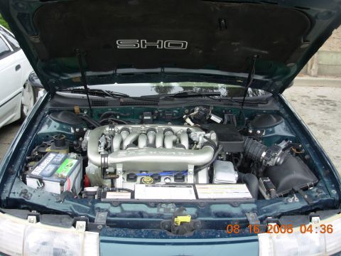 1995 Ford Taurus - Engine bay of a 1995 Ford Taurus SHO, showing the V6 engine and SHO badging.