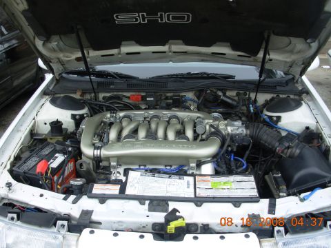 1995 Ford Taurus - Engine bay of a 1995 Ford Taurus SHO, showing the V8 engine and other components.