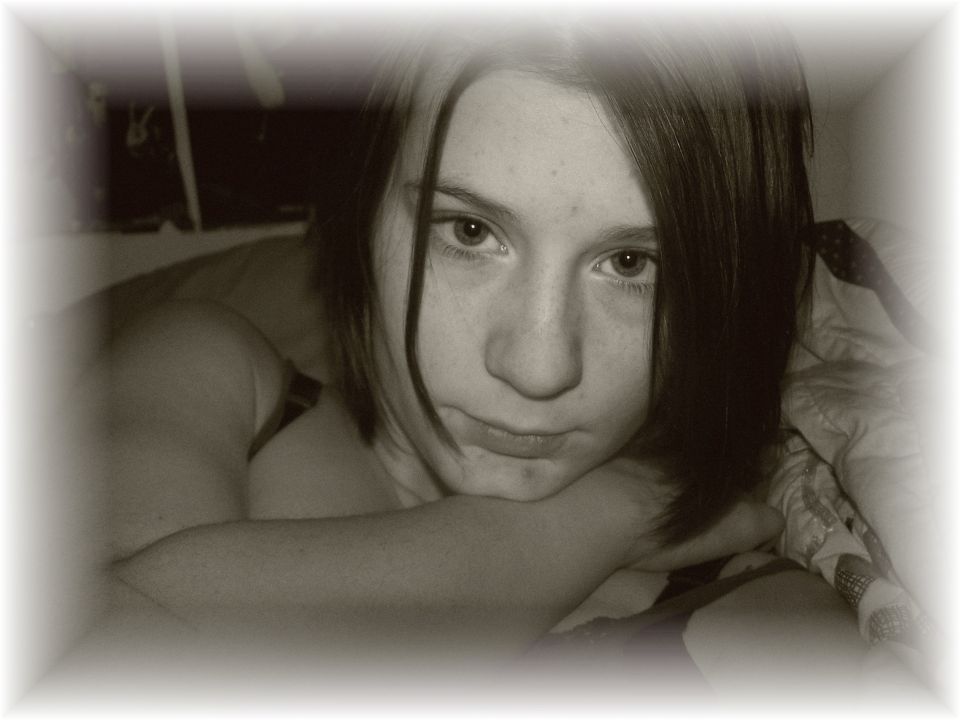 Portrait of a young person resting their head on their arms