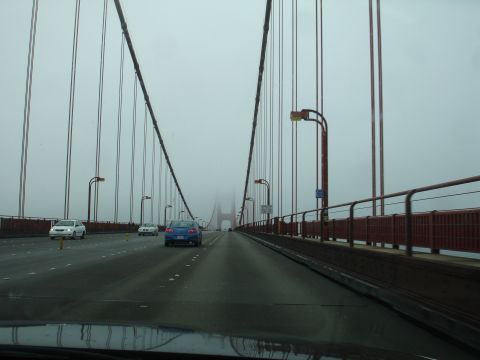 1990 Ford Taurus - View from a vehicle driving across the Golden Gate Bridge during a foggy day.