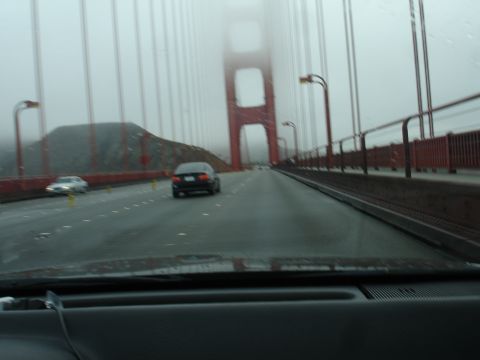 1990 Ford Taurus - View from inside a vehicle driving on the Golden Gate Bridge during a foggy day.