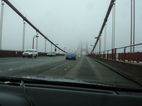 1990 Ford Taurus - The view from inside a vehicle driving across the Golden Gate Bridge on a foggy day.