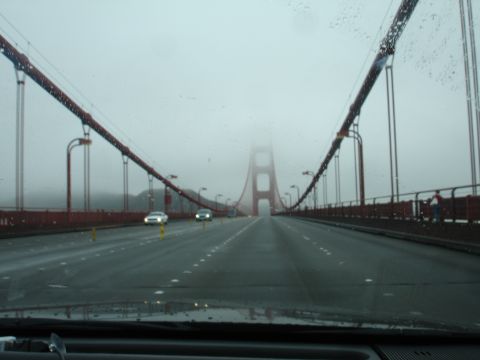 1990 Ford Taurus - Driving across the Golden Gate Bridge through fog with traffic visible.