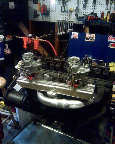 1953 Ford Mainline - Engine assembly with "OFFENHAUSER" intake manifold and dual carburetors in a workshop setting.
