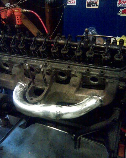 1953 Ford Mainline - Close-up view of an engine's valve train and a newly welded exhaust manifold.