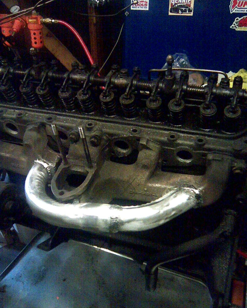 Engine with custom exhaust manifold and valve train visible