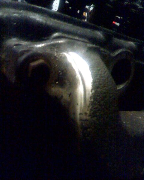 1953 Ford Mainline - This image shows a close-up of a vehicle's engine component, possibly a manifold or bracket.